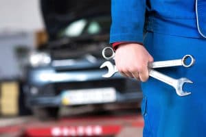 Hand of car mechanic with wrench. Auto repair garage., Auto Repair, Dr. Automotive